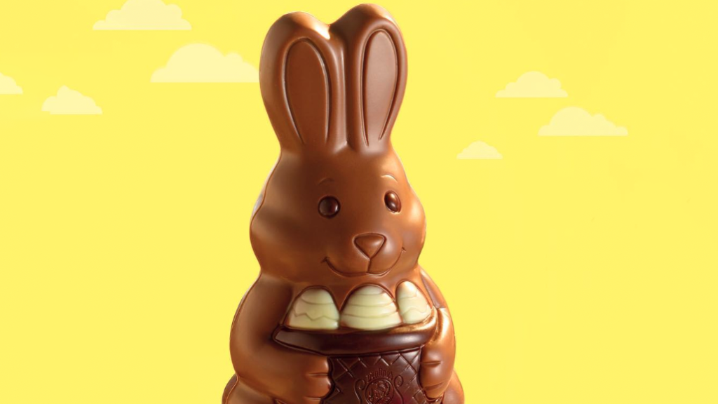 A choclate Easter bunny on a bright yellow background.
