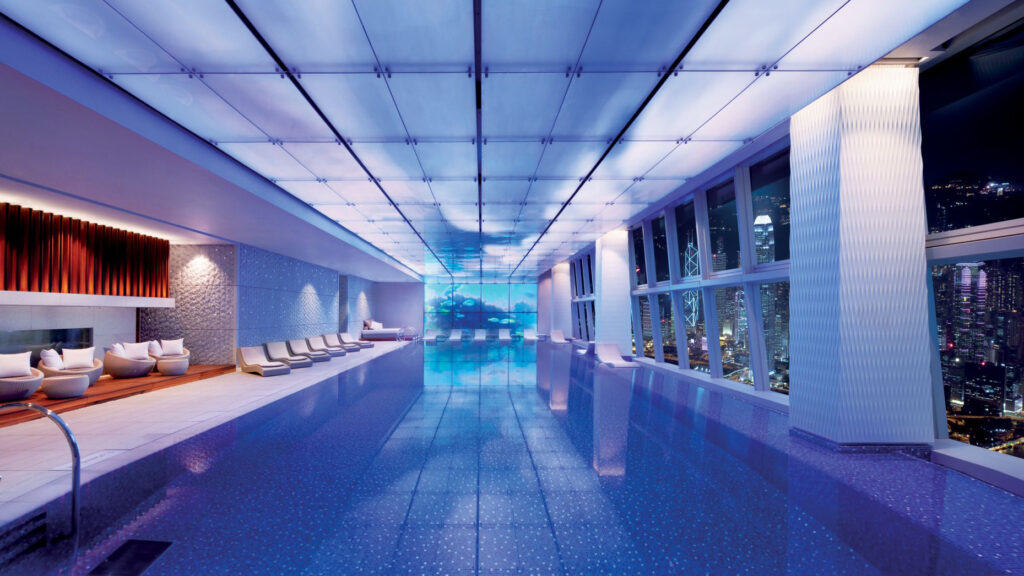 Indoor pool overlooking all the city lights of Hong Kong at night.