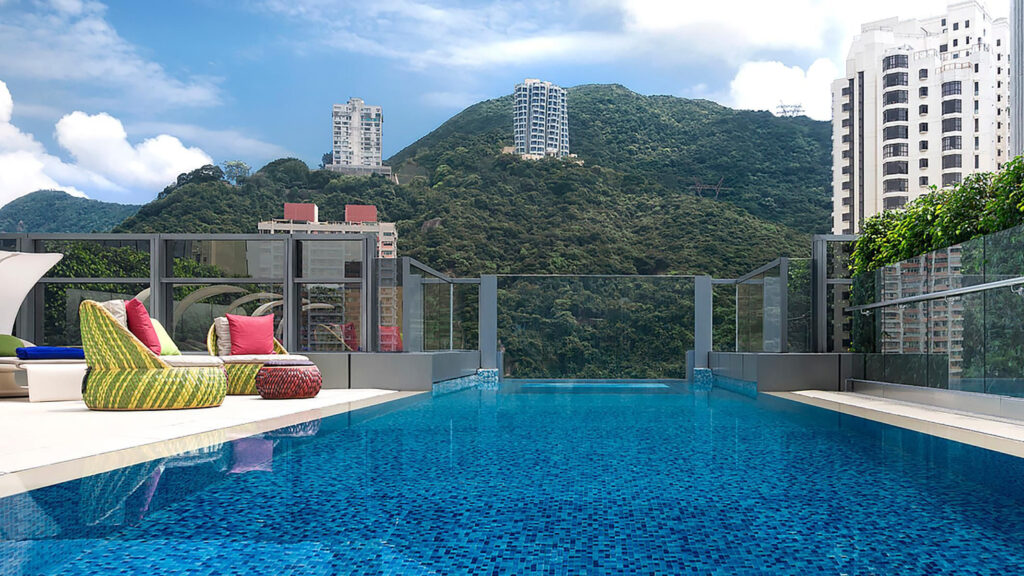 Infinity pool with colourful loungers beside the pool's edge.