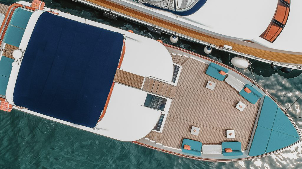 Aerial view of blue and orange yacht